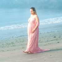 Maternity portrait on the sand by the ocean. Pregnant woman walking on the sand – NYC maternity photo