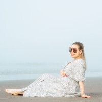 Elegant outdoor portrait of a pregnant woman by the coast. Pregnancy portrait outdoors on the coast – NYC photographer