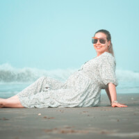 Pregnant woman photographed outdoors by the ocean. Outdoor maternity photography by the ocean – NYC photographer