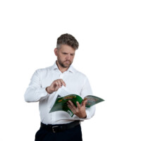 Studio portrait with strong and confident body language. Professional studio shot of man with a book – business style